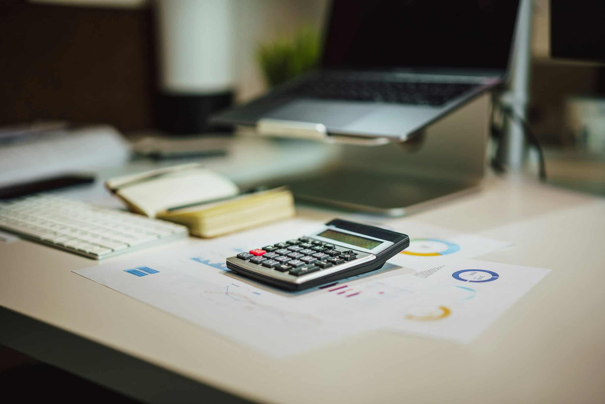 jakub-zerdzicki-8wLZi9OhsWU-unsplash calculator on table